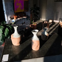 three vases sitting on a table in a room