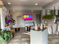 a living room with a tv and vases